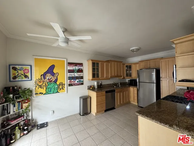 a kitchen with granite countertop stainless steel appliances a stove refrigerator and a sink