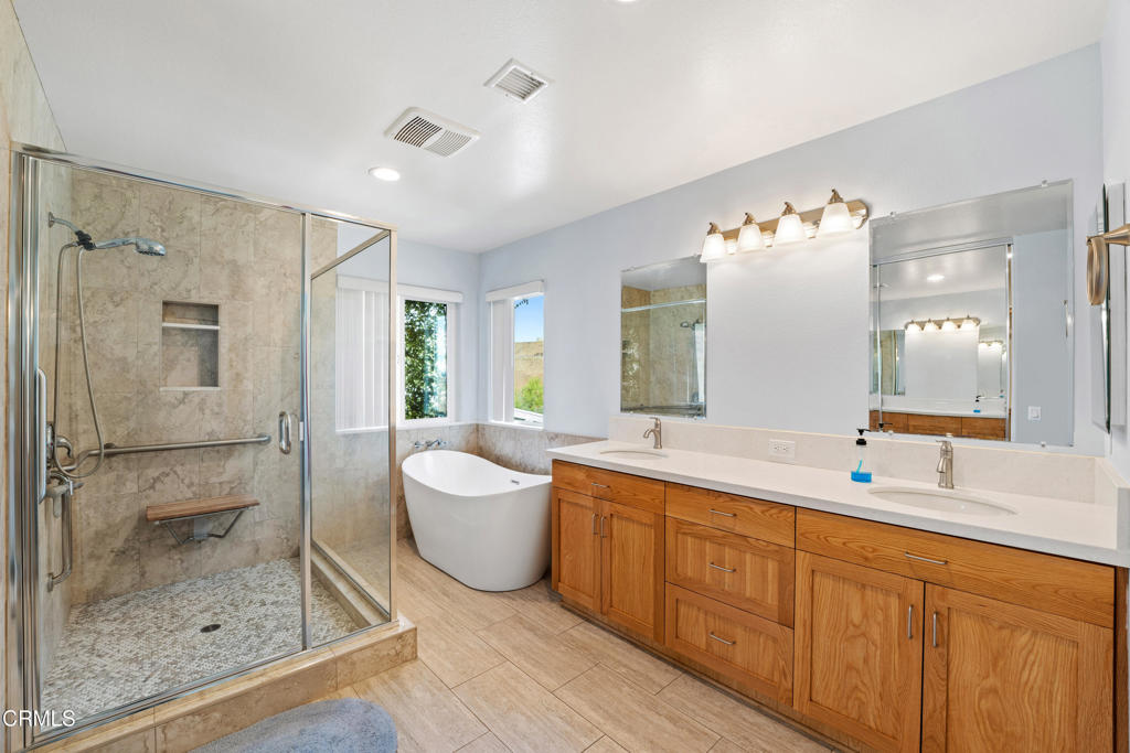 32650 The Old Road Castaic, CA 91384 - Photo 16 of 31 a spacious bathroom with a double vanity sink mirror and shower