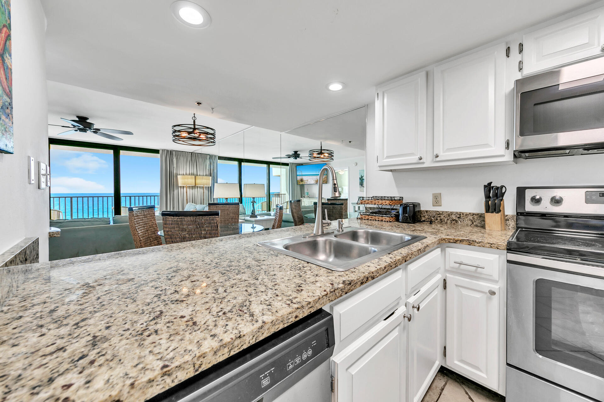 4100 East County Highway 30A, Unit 803 Santa Rosa Beach, FL 32459 - Photo 5 of 34 a kitchen with granite countertop a sink stove and cabinets