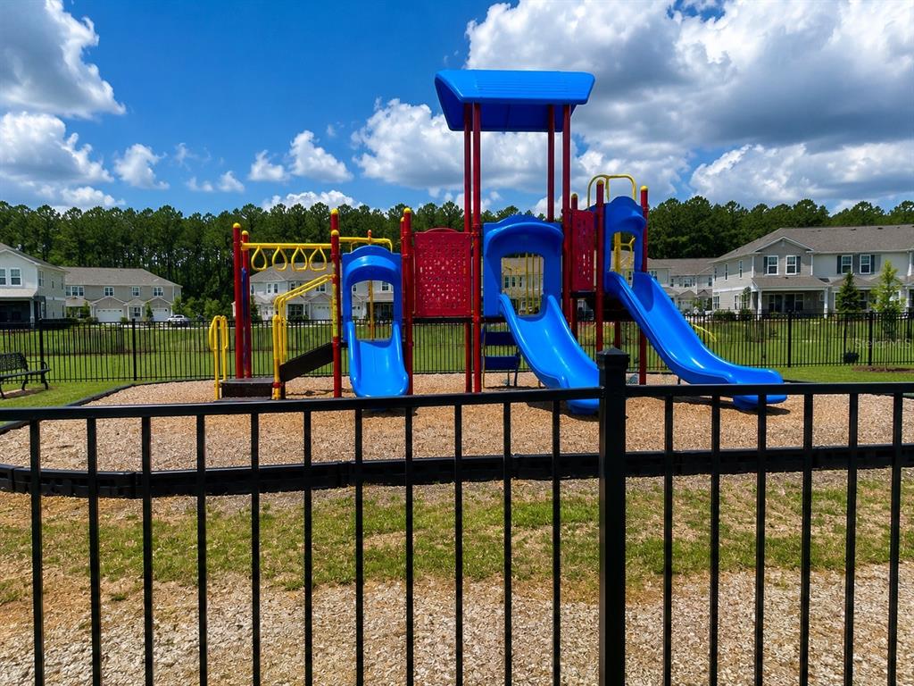 339 Redbud Road Palm Coast, FL 32137 - Photo 22 of 22 a view of a houses with furniture and a yard