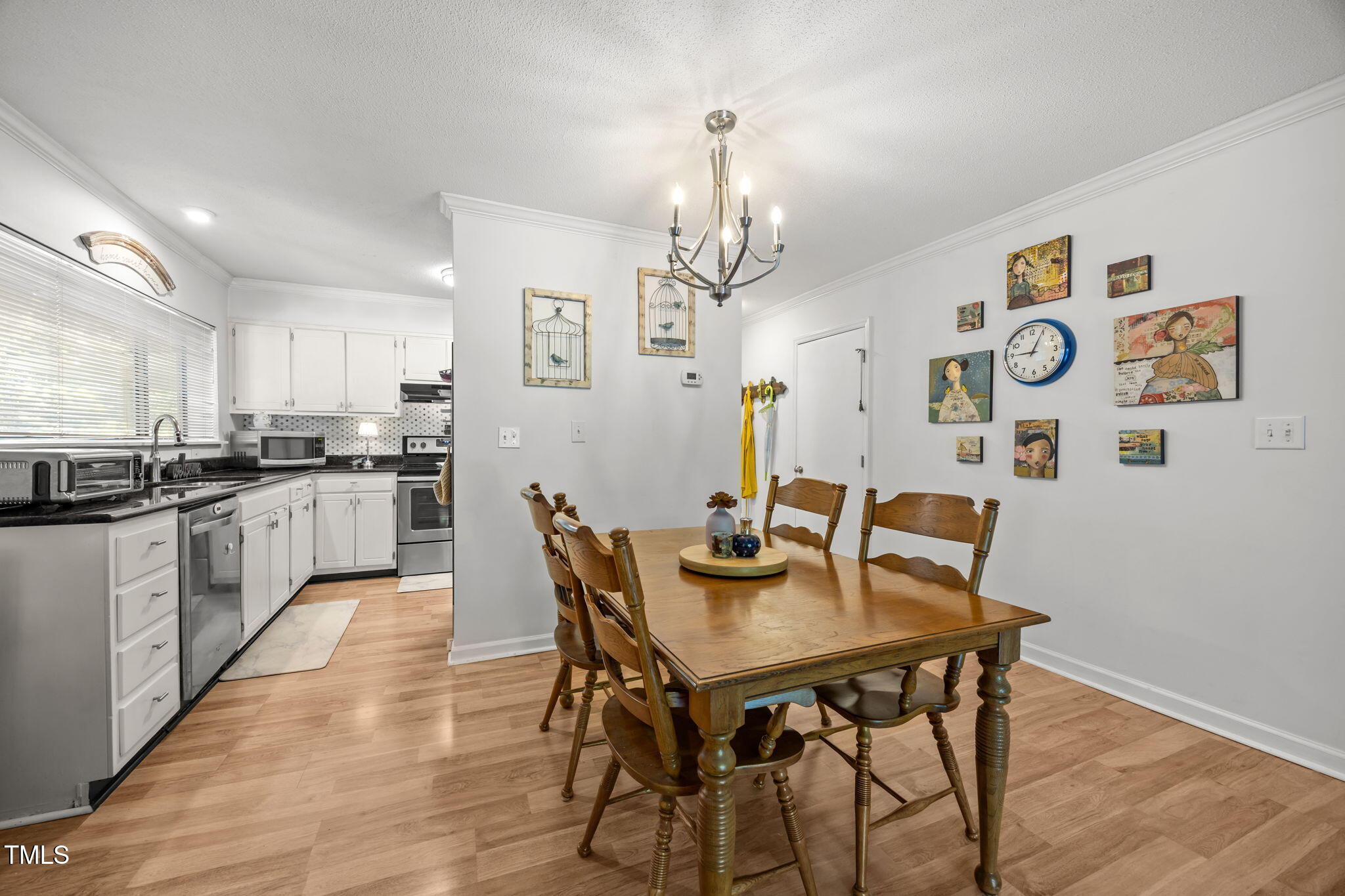 5024 Flint Ridge Place Raleigh, NC 27609 - Photo 12 of 46 a view of a dining room with furniture and wooden floor
