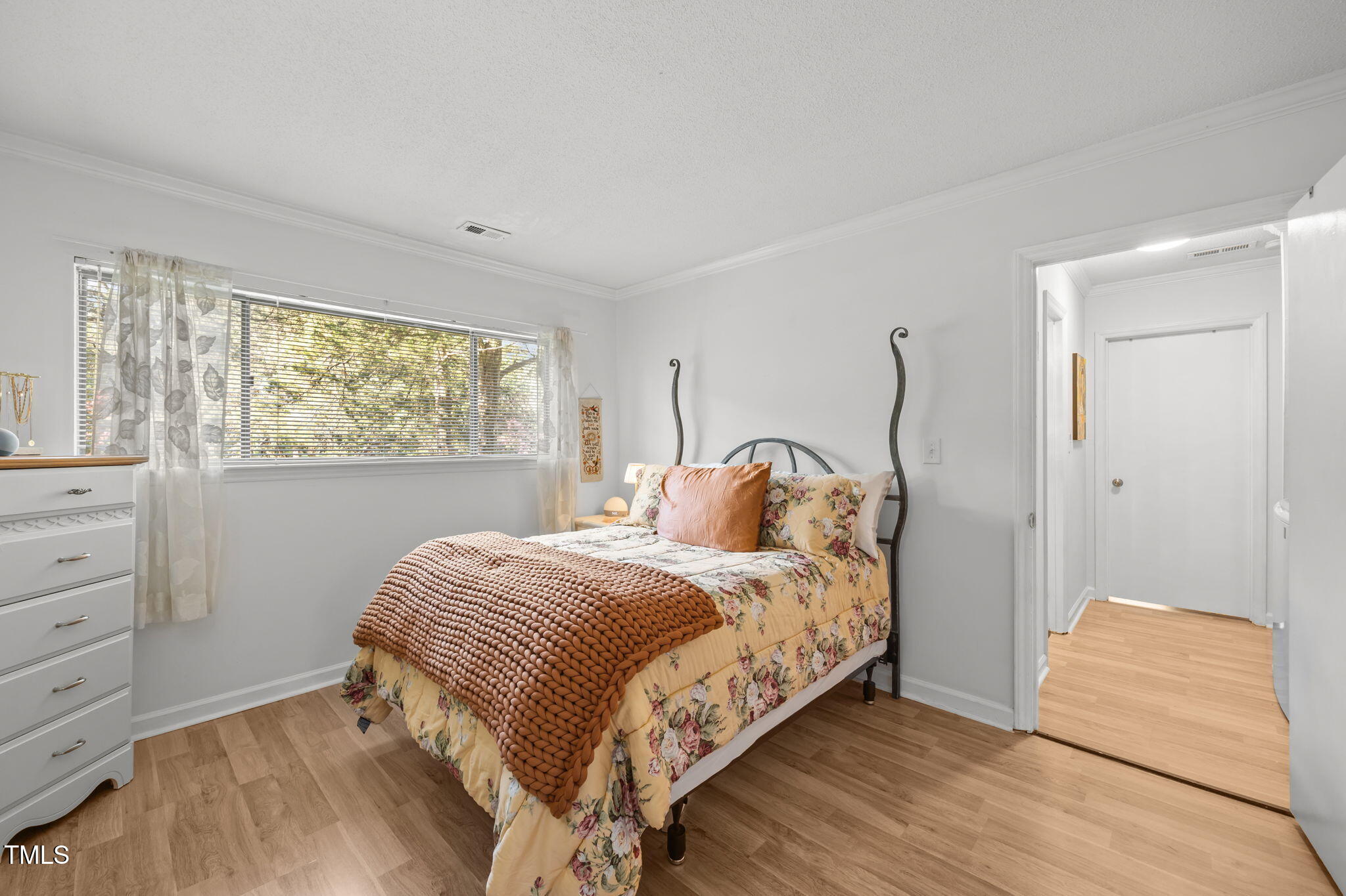 5024 Flint Ridge Place Raleigh, NC 27609 - Photo 28 of 46 a bedroom with a bed and a window