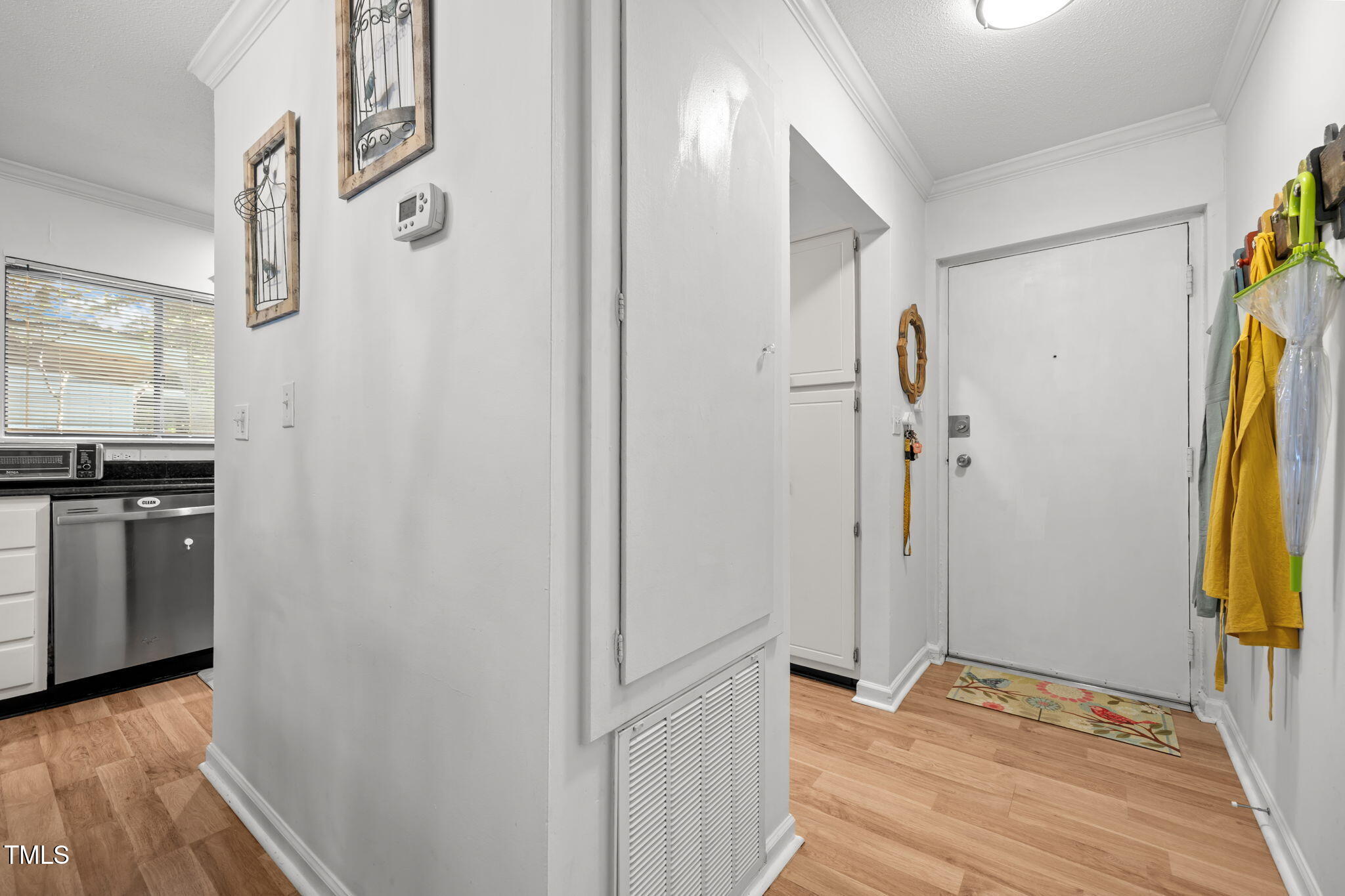 5024 Flint Ridge Place Raleigh, NC 27609 - Photo 5 of 46 a view of a room with a closet and wooden floor