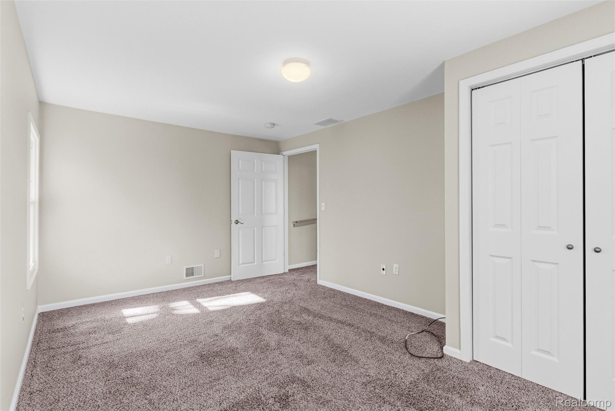 4191 McCandlish Road Grand Blanc, MI 48439 - Photo 30 of 53 Unfurnished bedroom with a closet and carpet flooring