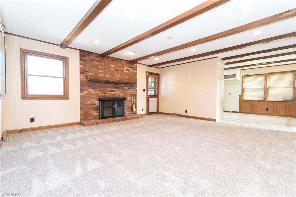 8151 Center Grove Church Road Clemmons, NC 27012 - Photo 11 of 30 Den with wood burning fireplace, fresh carpet and paint