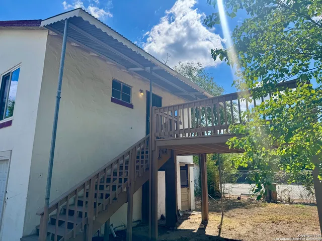 a view of a porch with furniture and garden