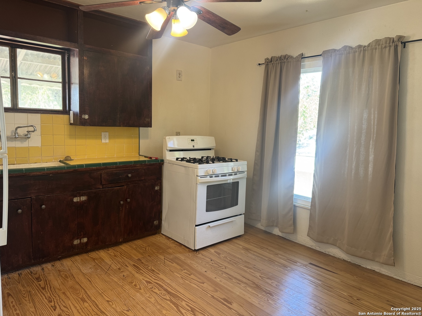 108 Robert E Lee, Unit 2 San Antonio, TX 78214 - Photo 7 of 8 a kitchen with stainless steel appliances granite countertop a stove a sink and a refrigerator