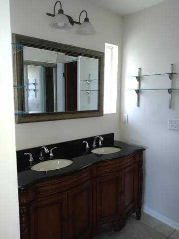 a bathroom with a sink and a mirror