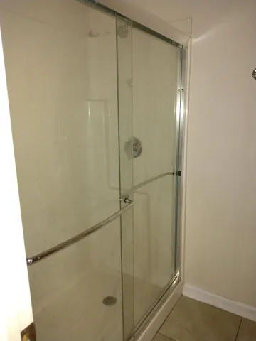 a bathroom with a glass shower door