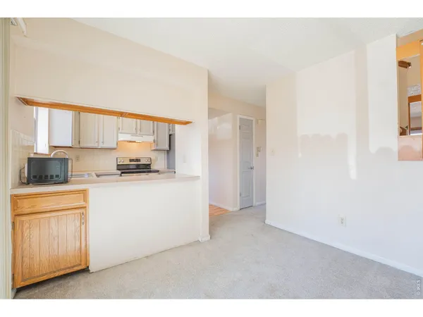a kitchen with cabinets and a window