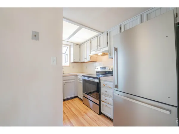a kitchen with a refrigerator and a stove