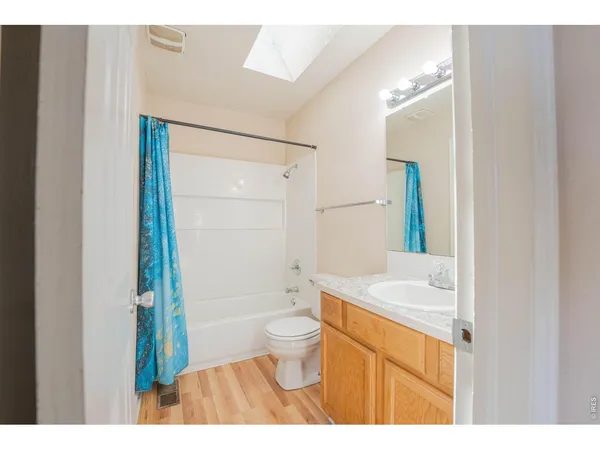 a bathroom with a sink a toilet a mirror and shower