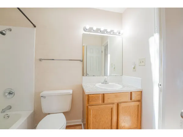 a bathroom with a sink and mirror with toilet