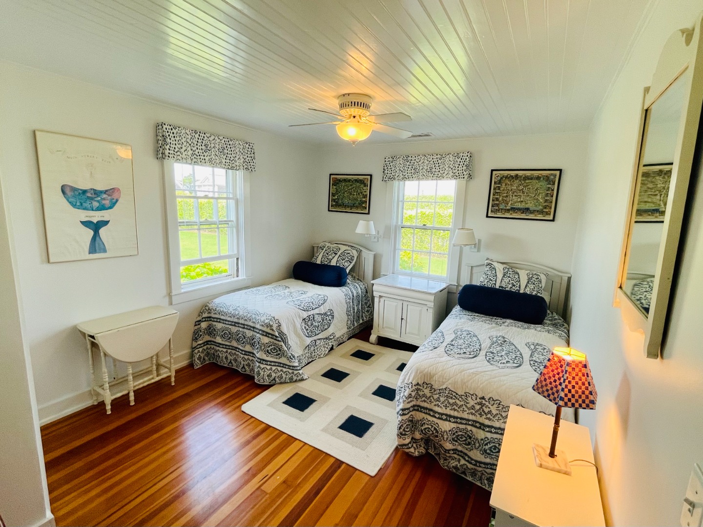 76 Baxter Road Nantucket, MA 02554 - Photo 13 of 25 a bedroom with a bed a dresser with wooden floor