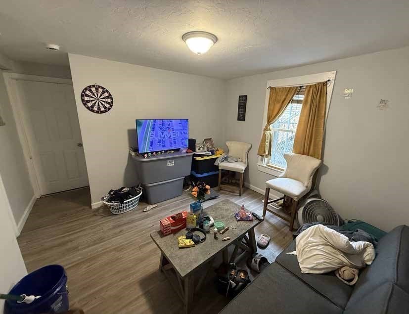 8 Cherry Street Lowell, MA 01852 - Photo 12 of 17 a living room with furniture and a window