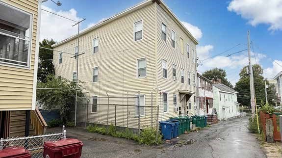8 Cherry Street Lowell, MA 01852 - Photo 3 of 17 a front view of a house with a yard