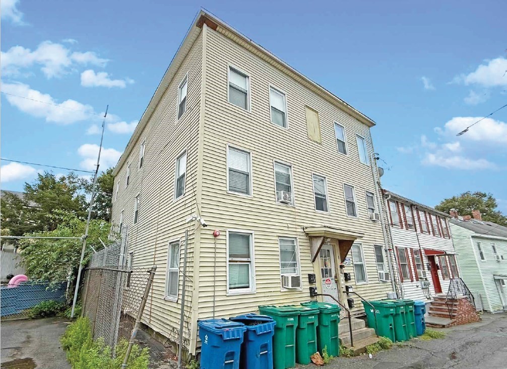 8 Cherry Street Lowell, MA 01852 - Photo 4 of 17 a front view of a house with a yard