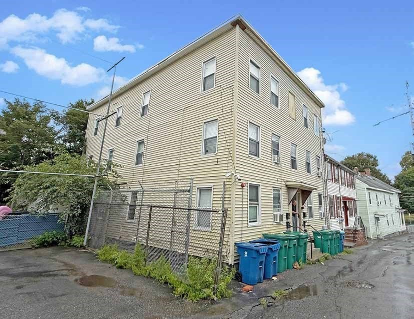 8 Cherry Street Lowell, MA 01852 - Photo 6 of 17 a front view of a house with a yard