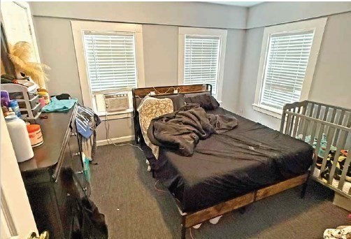 8 Cherry Street Lowell, MA 01852 - Photo 9 of 17 a bedroom with a bed a couch and windows