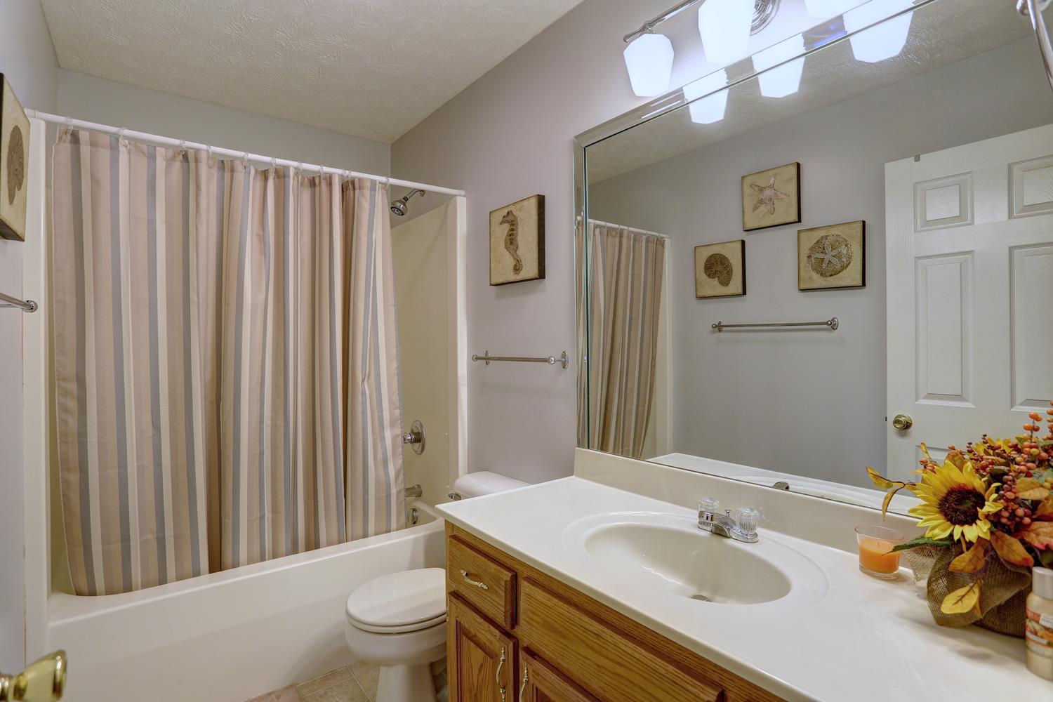 105 Lear Road Portland, TN 37148 - Photo 15 of 25 a bathroom with a sink a toilet and shower curtain