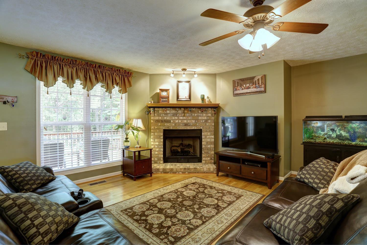 105 Lear Road Portland, TN 37148 - Photo 3 of 25 a living room with furniture a flat screen tv and a fireplace