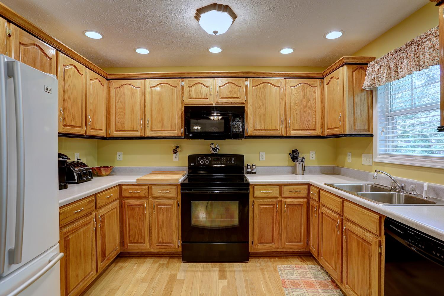 105 Lear Road Portland, TN 37148 - Photo 6 of 25 a kitchen with a sink a stove and cabinets
