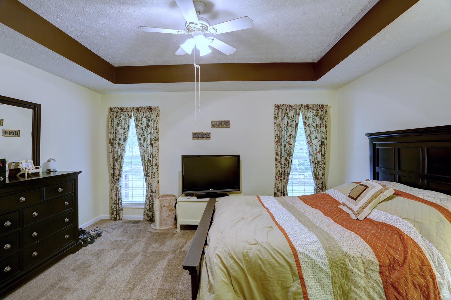105 Lear Road Portland, TN 37148 - Photo 10 of 25 a bedroom with a bed and a flat screen tv