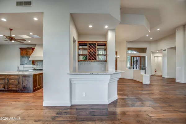 a kitchen with stainless steel appliances granite countertop a stove a sink and a microwave
