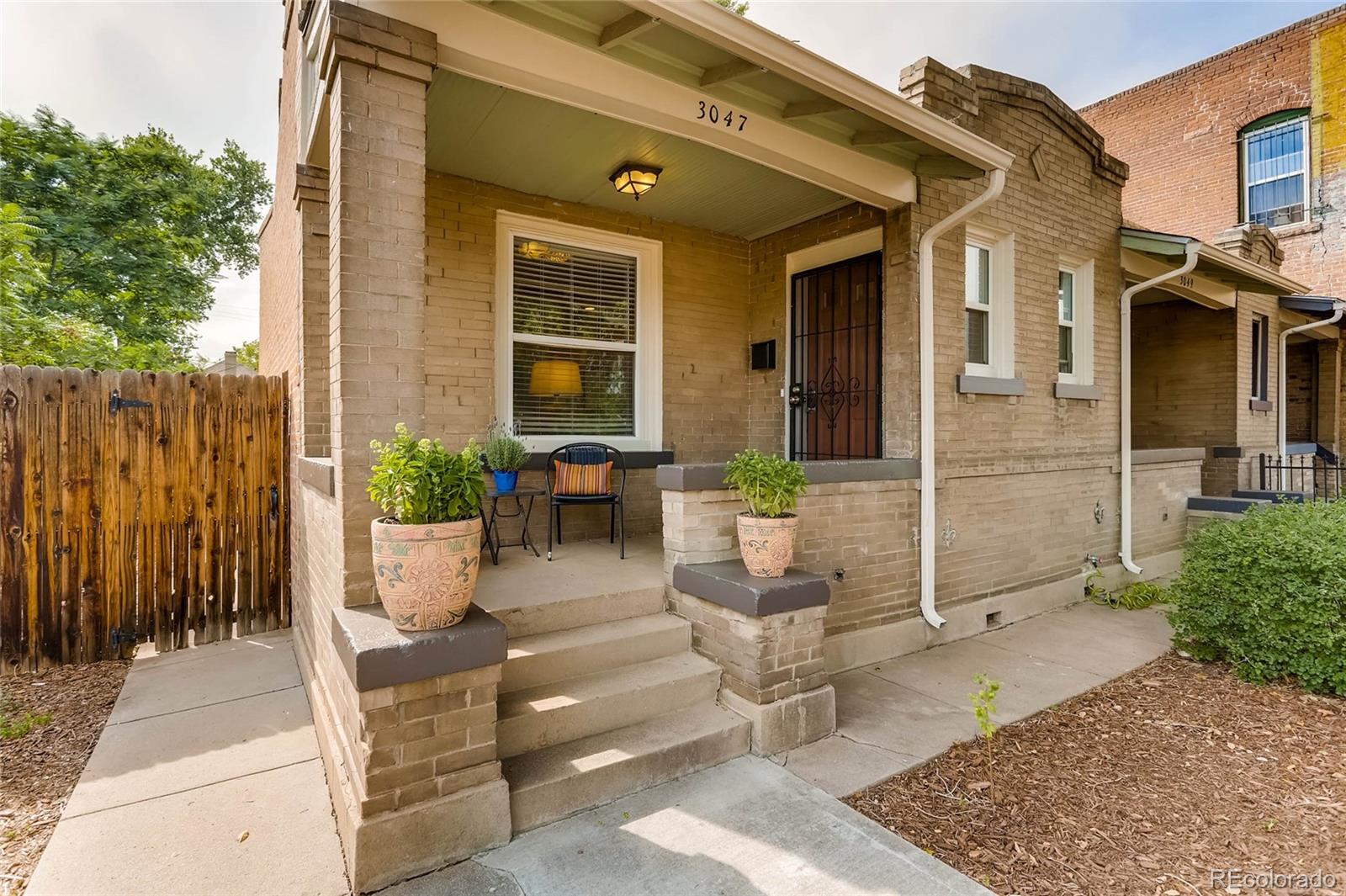 a view of house with patio outdoor seating and plants