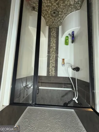 a bathroom with a double vanity sink and a mirror