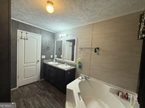 a view of a hallway view with wooden floor and staircase