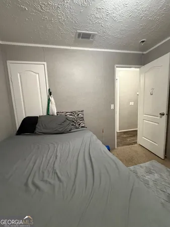 a bedroom with bed and a window