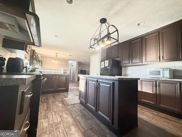 a kitchen with a stove and a microwave
