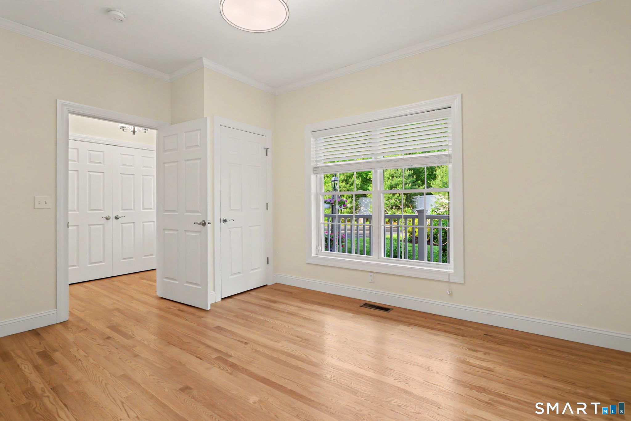 223 Meadow Brook Road, Unit 223 Oxford, CT 06478 - Photo 21 of 34 a view of an empty room with wooden floor and a window