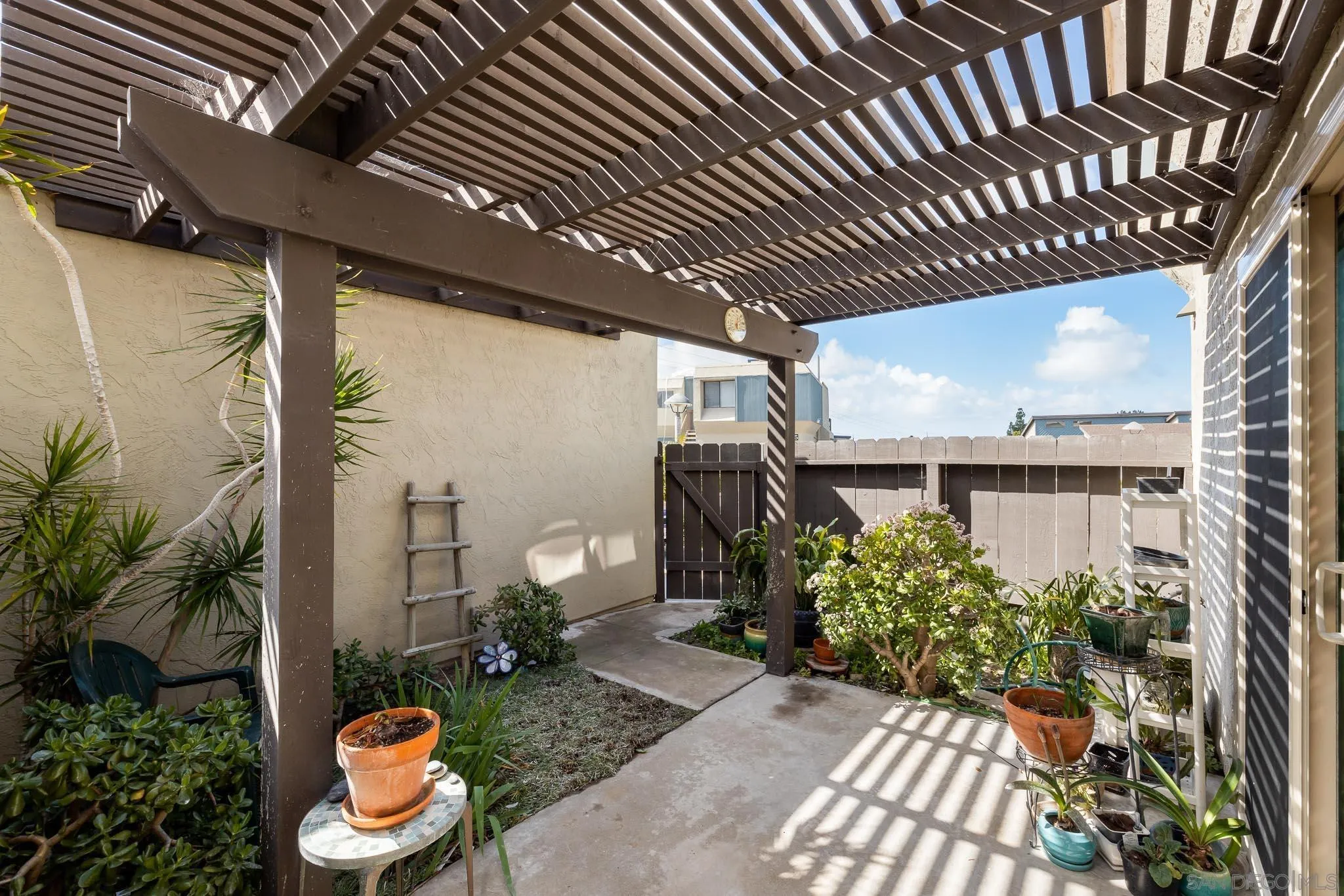 6377 Rancho Mission Road, Unit 4 San Diego, CA 92108 - Photo 8 of 23 a view of a porch with potted plants