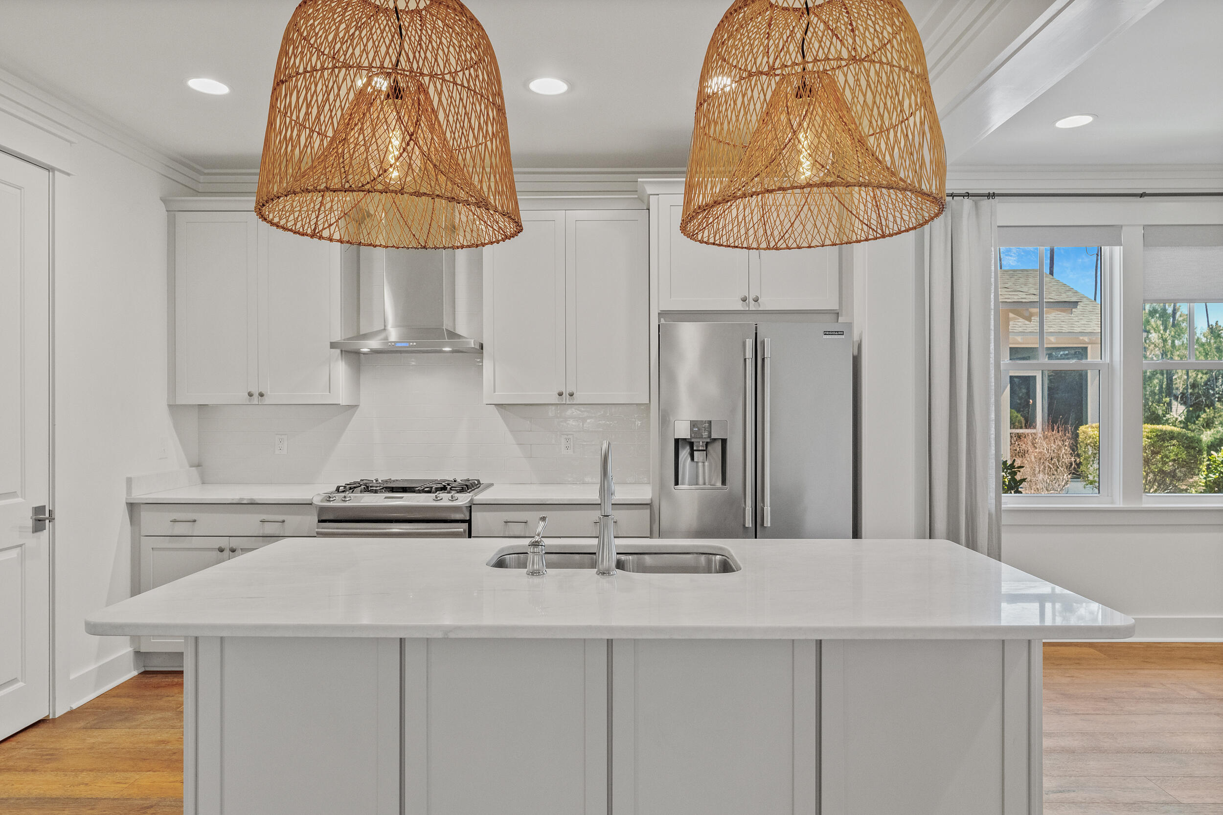 77 Cannonball Lane, Unit LOT (174) Inlet Beach, FL 32461 - Photo 11 of 46 a kitchen with stainless steel appliances a sink a table and chandelier