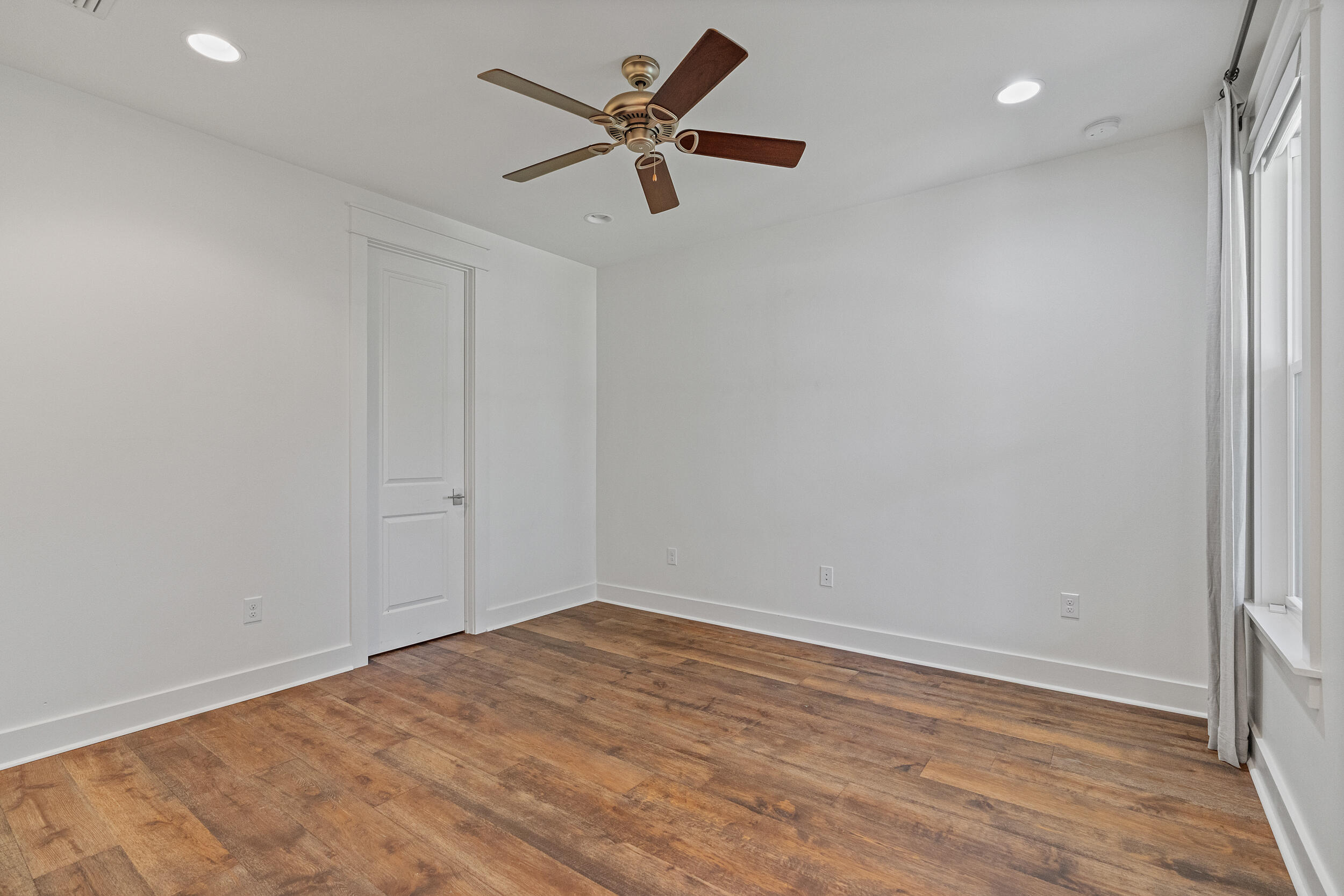 77 Cannonball Lane, Unit LOT (174) Inlet Beach, FL 32461 - Photo 20 of 46 an empty room with wooden floor and ceiling fan