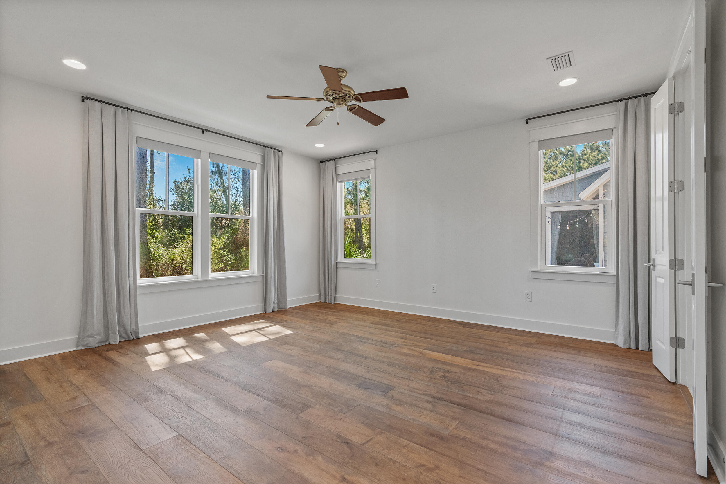 77 Cannonball Lane, Unit LOT (174) Inlet Beach, FL 32461 - Photo 25 of 46 a view of an empty room with a window and wooden floor