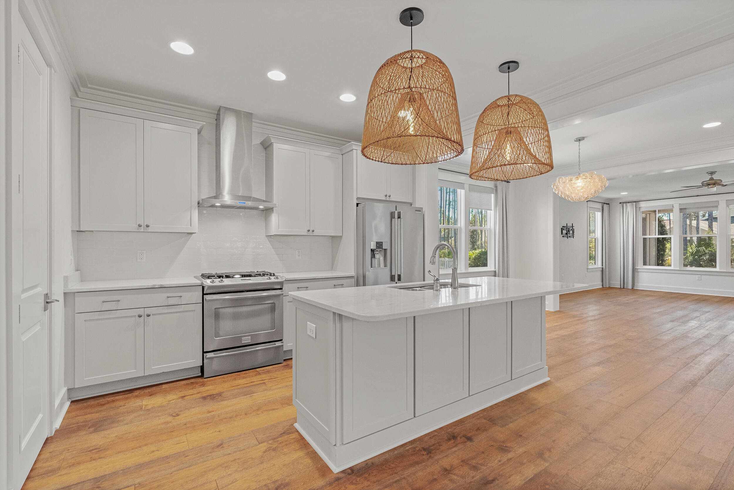 77 Cannonball Lane, Unit LOT (174) Inlet Beach, FL 32461 - Photo 6 of 46 a kitchen with cabinets a sink stainless steel appliances and wooden floor
