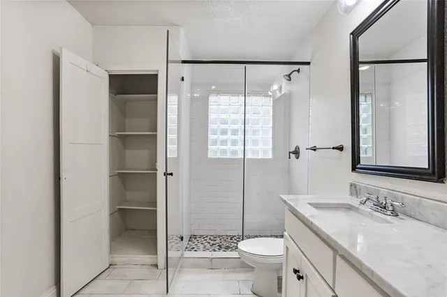 a bathroom with a sink toilet and shower