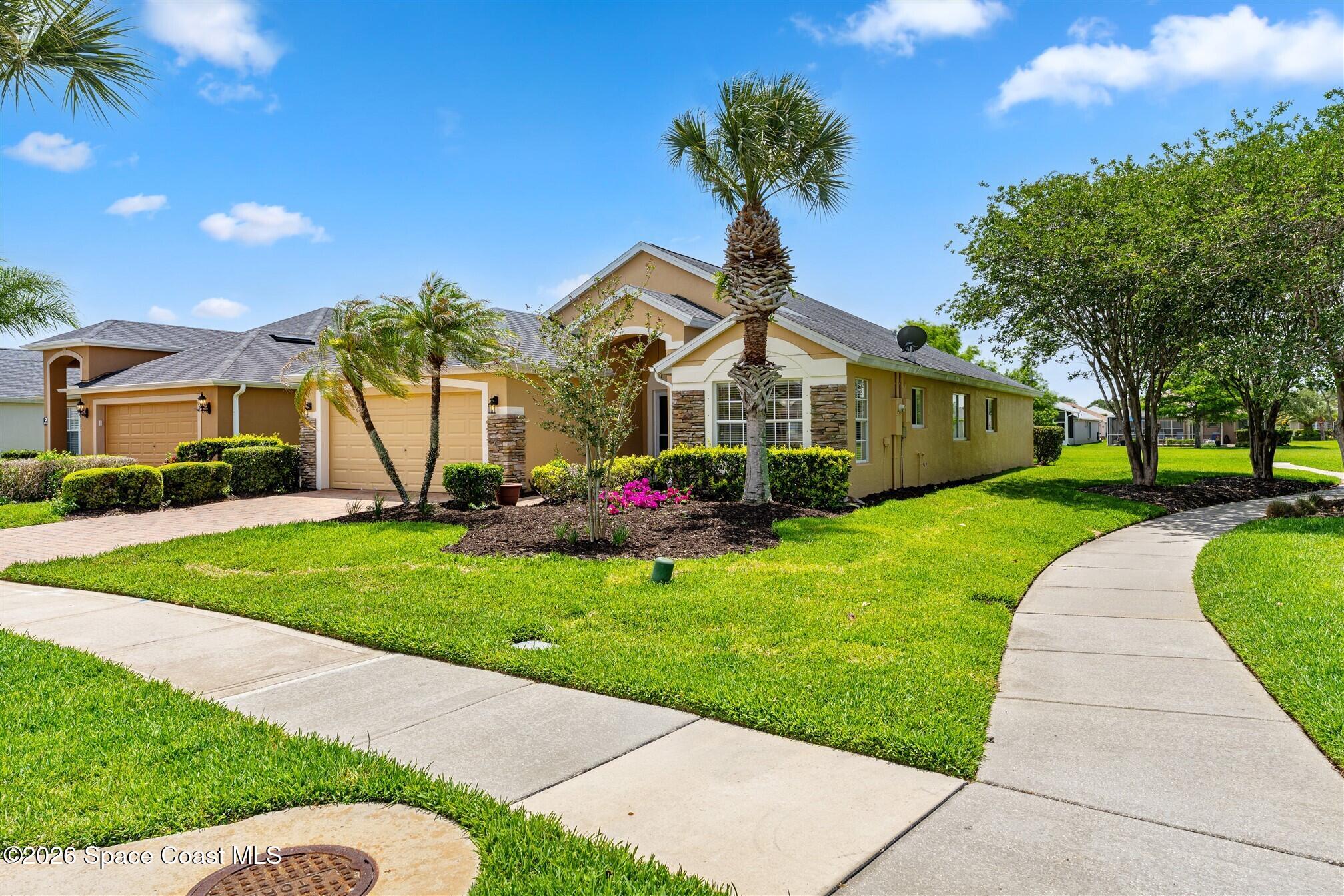6904 Renshaw Drive Melbourne, FL 32940 - Photo 2 of 46 a front view of a house with garden