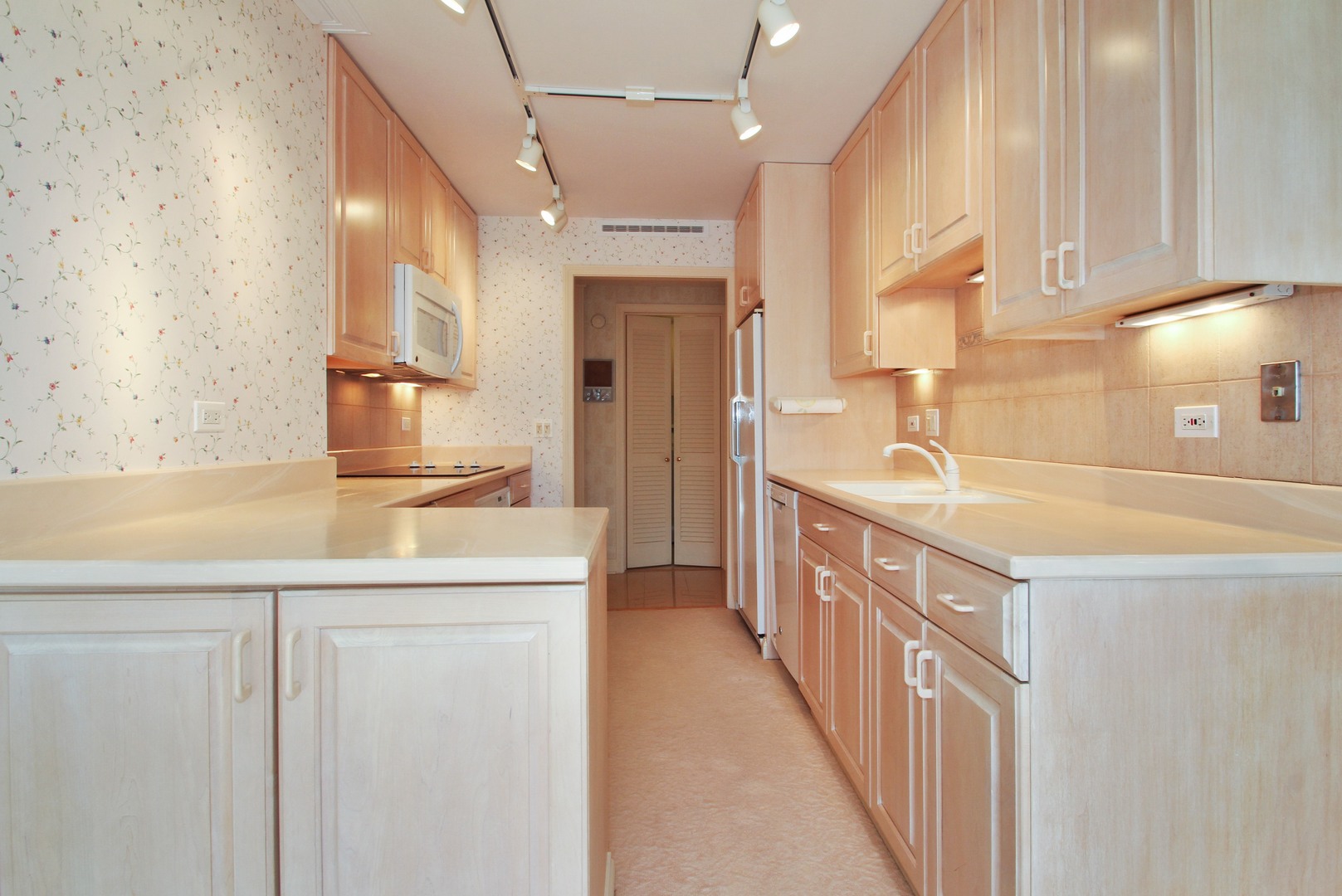 22 Park Lane, Unit 518 Park Ridge, IL 60068 - Photo 8 of 21 a kitchen with stainless steel appliances granite countertop a sink and a refrigerator