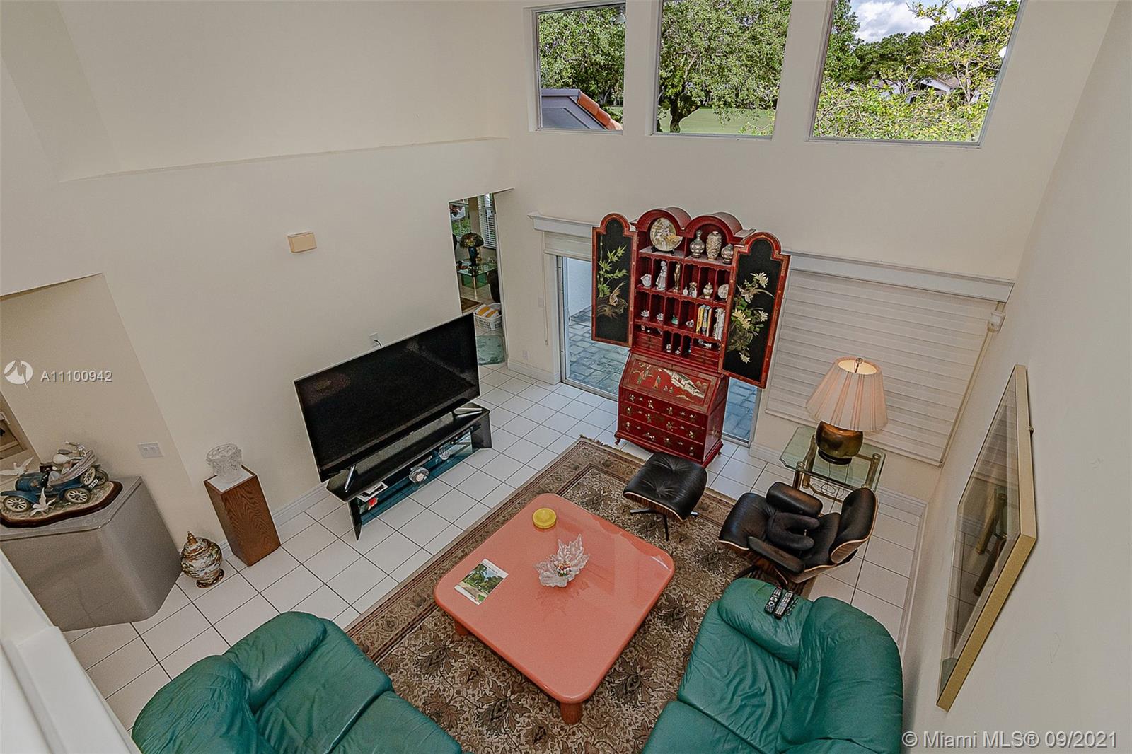 2295 Northwest 53rd Street Boca Raton, FL 33496 - Photo 11 of 25 a living room with furniture and a flat screen tv