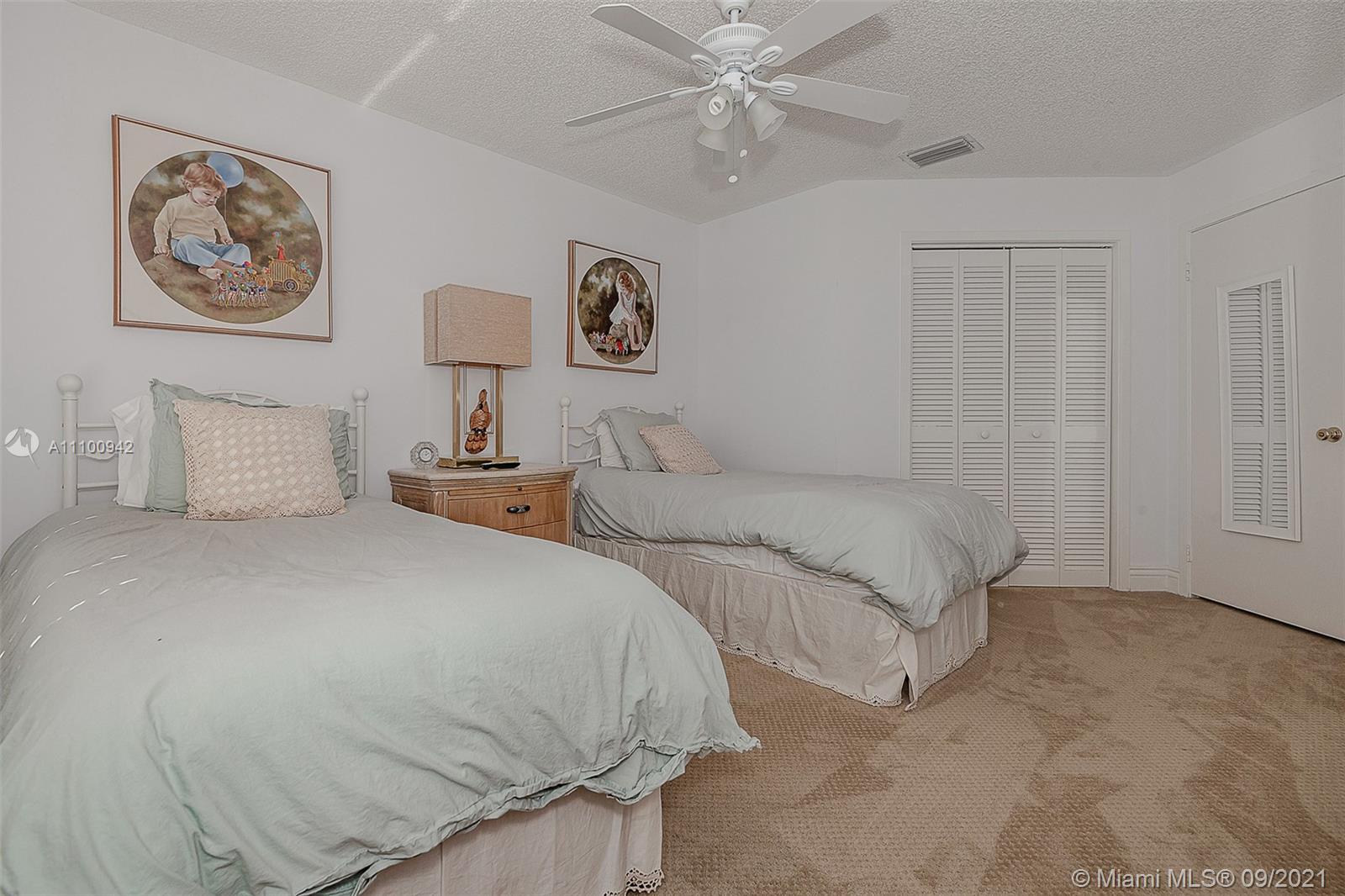 2295 Northwest 53rd Street Boca Raton, FL 33496 - Photo 16 of 25 a bedroom with bed and wall painting