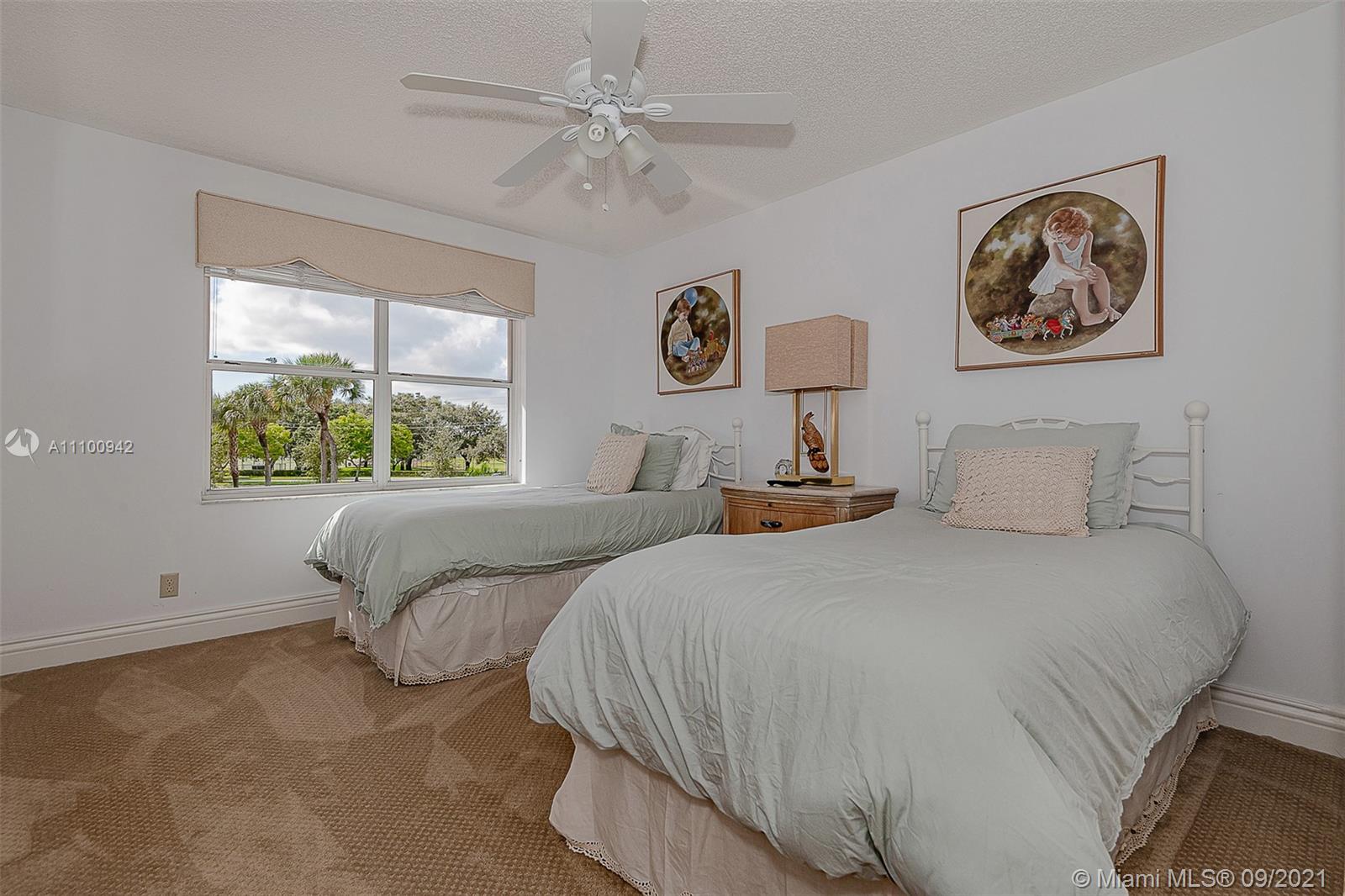 2295 Northwest 53rd Street Boca Raton, FL 33496 - Photo 19 of 25 a bedroom with a bed and a window