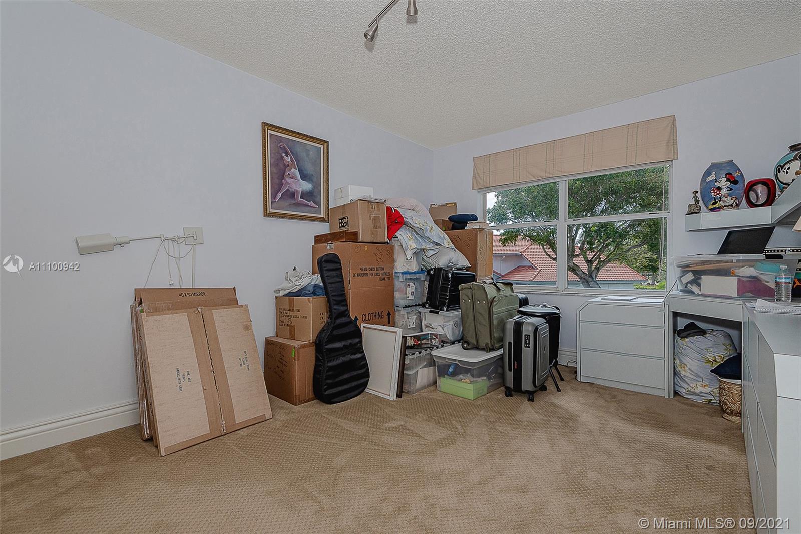 2295 Northwest 53rd Street Boca Raton, FL 33496 - Photo 20 of 25 a view of a workspace with furniture and a livingroom