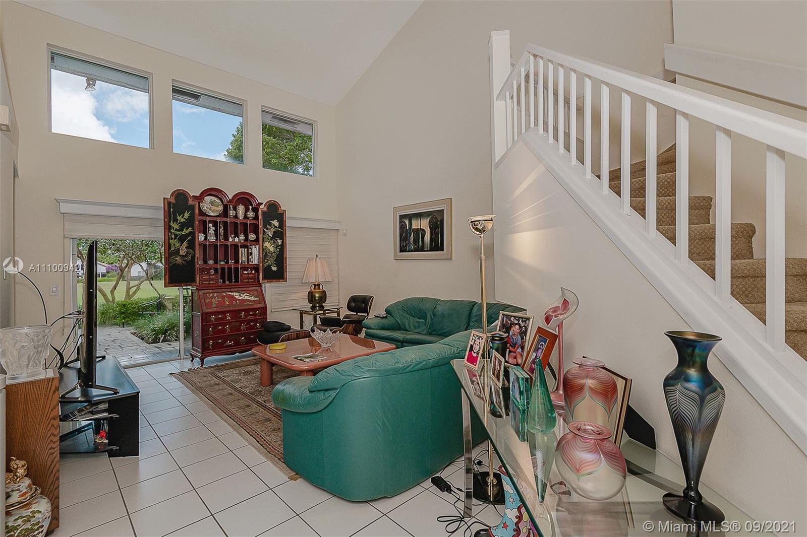 2295 Northwest 53rd Street Boca Raton, FL 33496 - Photo 3 of 25 a living room with furniture and a potted plant