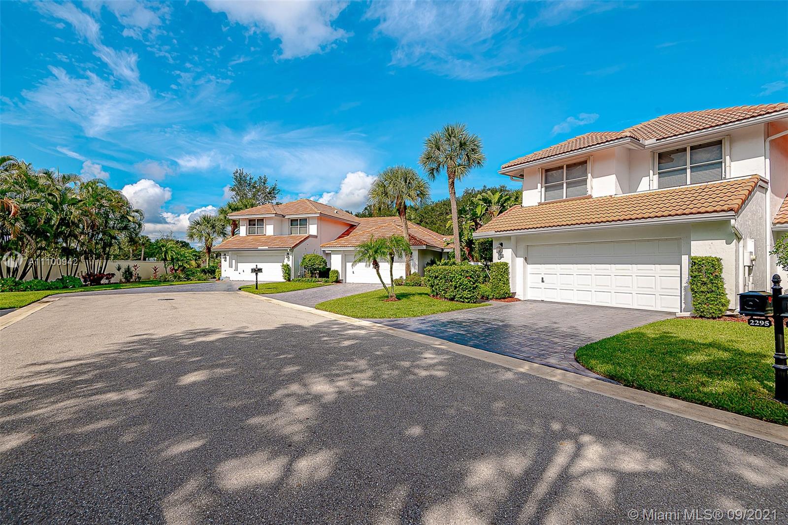 2295 Northwest 53rd Street Boca Raton, FL 33496 - Photo 21 of 25 a front view of a house with a yard and garage