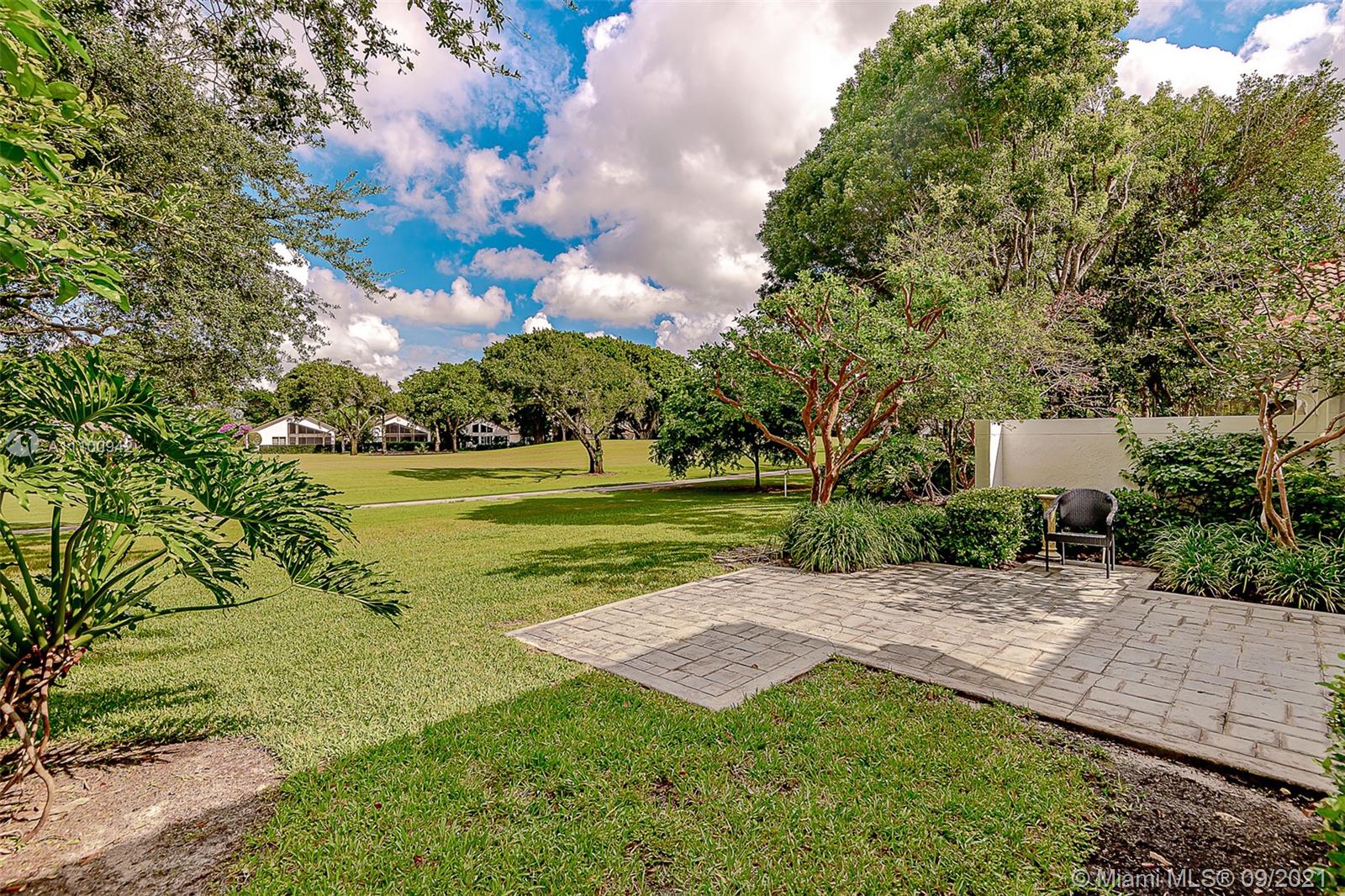 2295 Northwest 53rd Street Boca Raton, FL 33496 - Photo 23 of 25 a view of a garden with a building in the background