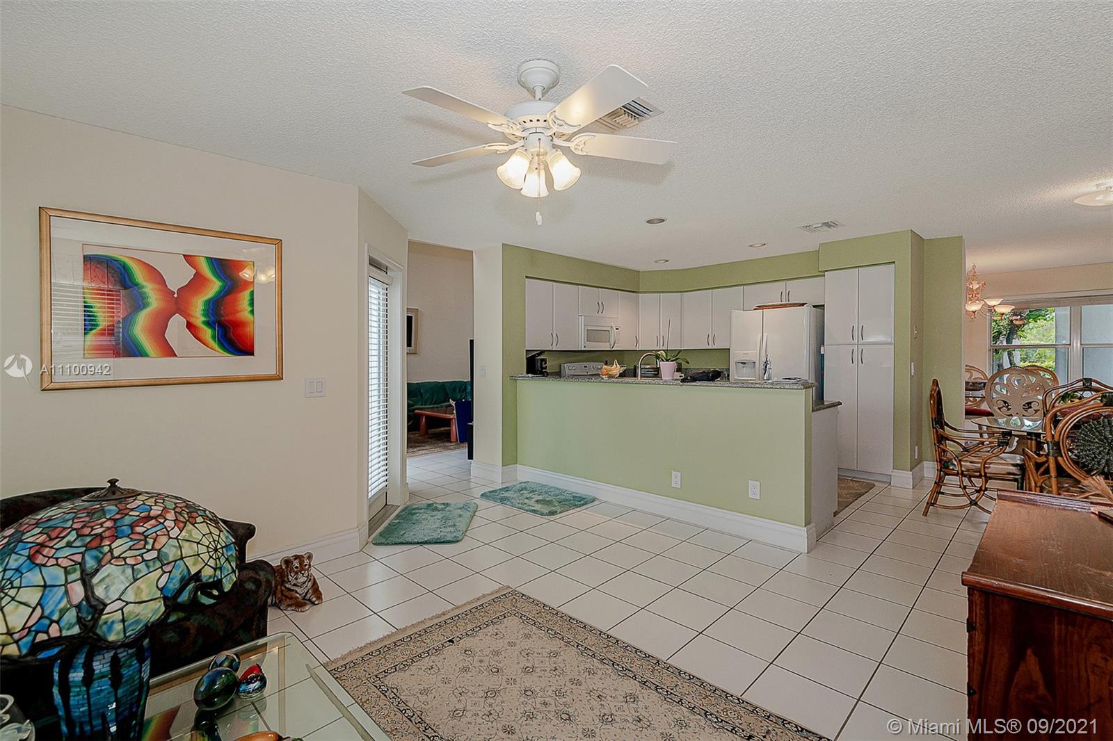 2295 Northwest 53rd Street Boca Raton, FL 33496 - Photo 5 of 25 a living room with furniture and kitchen view